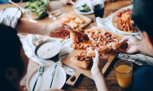 people eating pizza at a restaurant