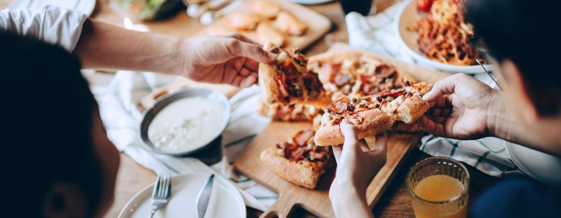 people eating pizza at a restaurant