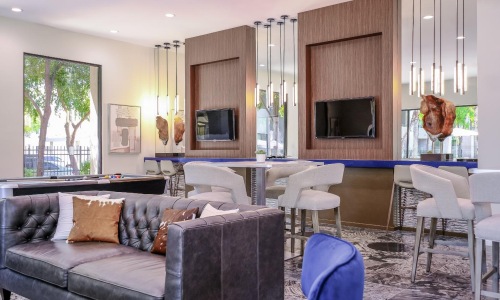 a living room with a couch and chairs