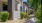 a building with bushes and trees